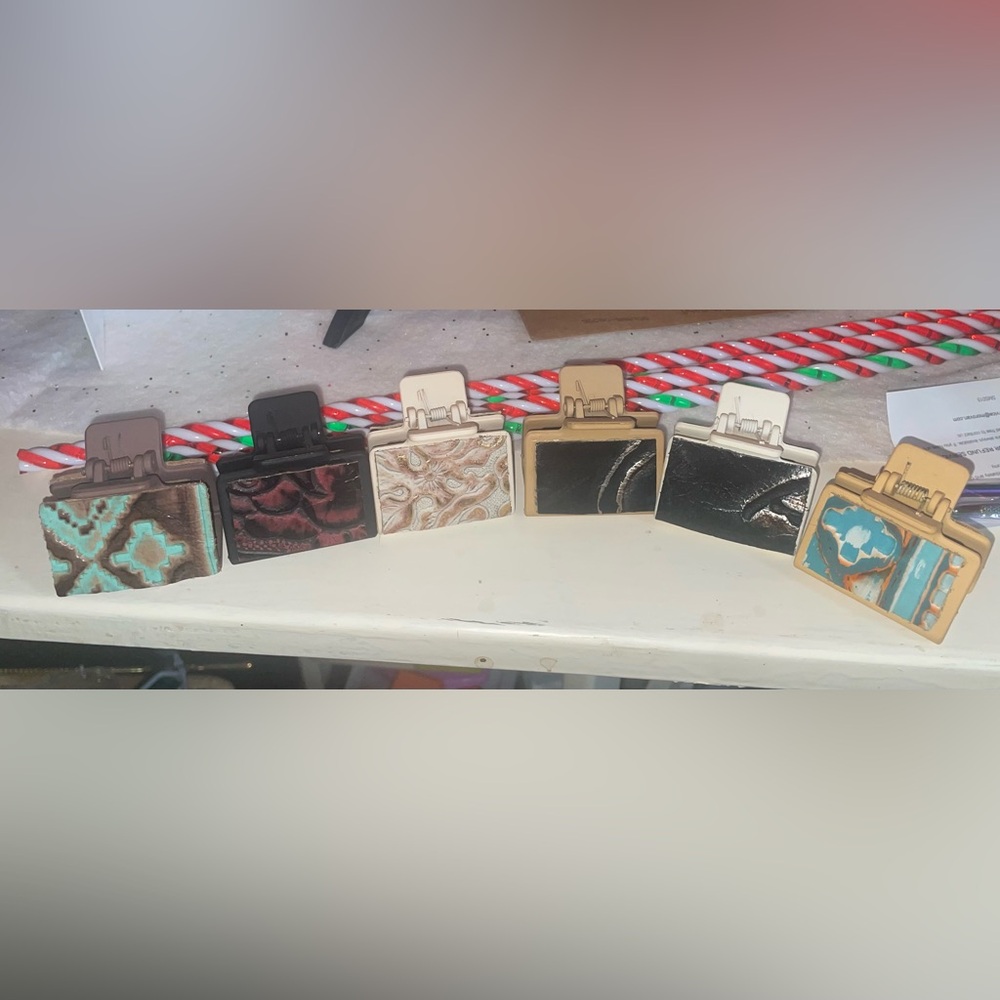 Set of Six Decorative Clips with leather on them